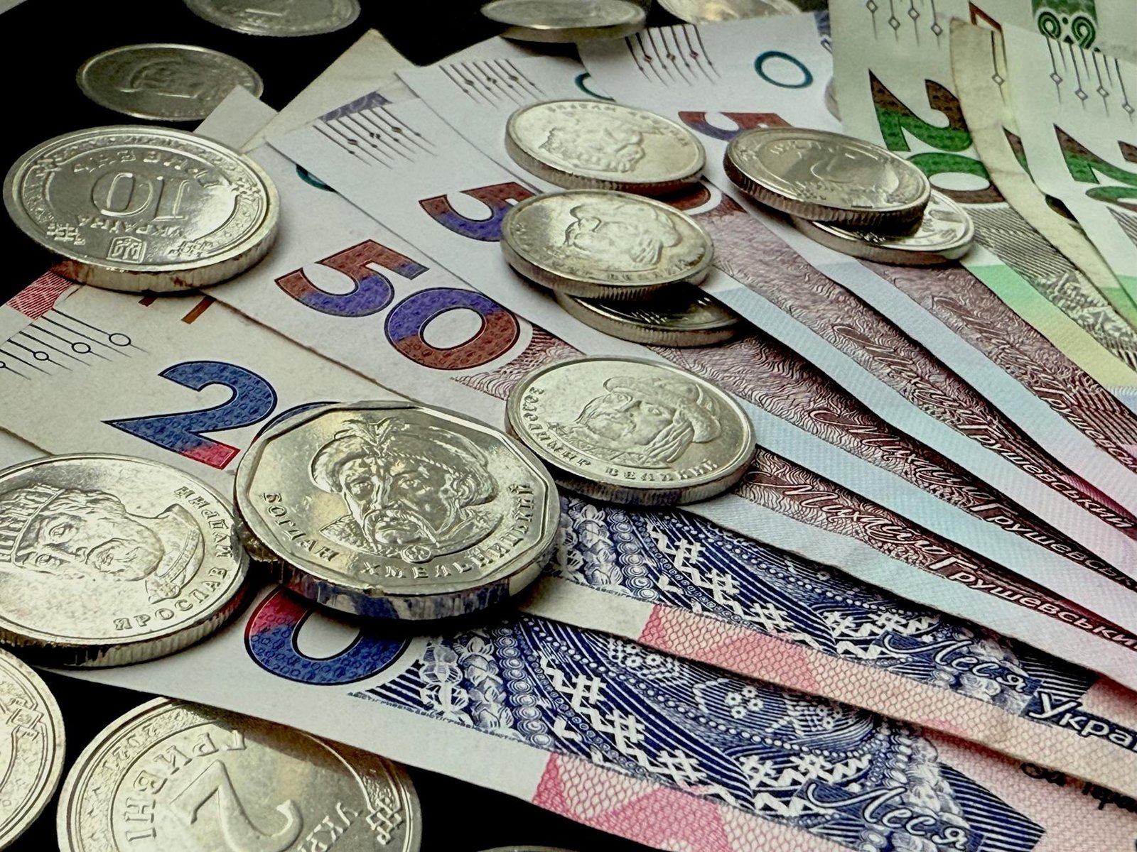 Close-up of various coins and banknotes from different countries, showcasing diversity in currency.